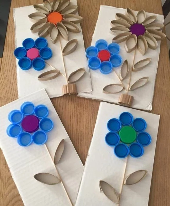 craft ideas for kids, four pieces of carboard, decorated with flowers made from used bottle caps, and pieces of toilet roll