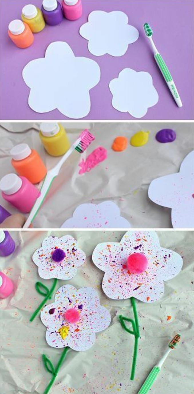 craft ideas for kids, four small bottles of paint, near flower-shaped cutouts and a green toothbrush, toothbrush dipped in paint and used over paper, finished flowers decorated with paint