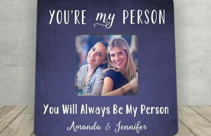 best friend gift ideas, large dark blue or violet frame, decorated with writing in white, containing small photo of two smiling young women
