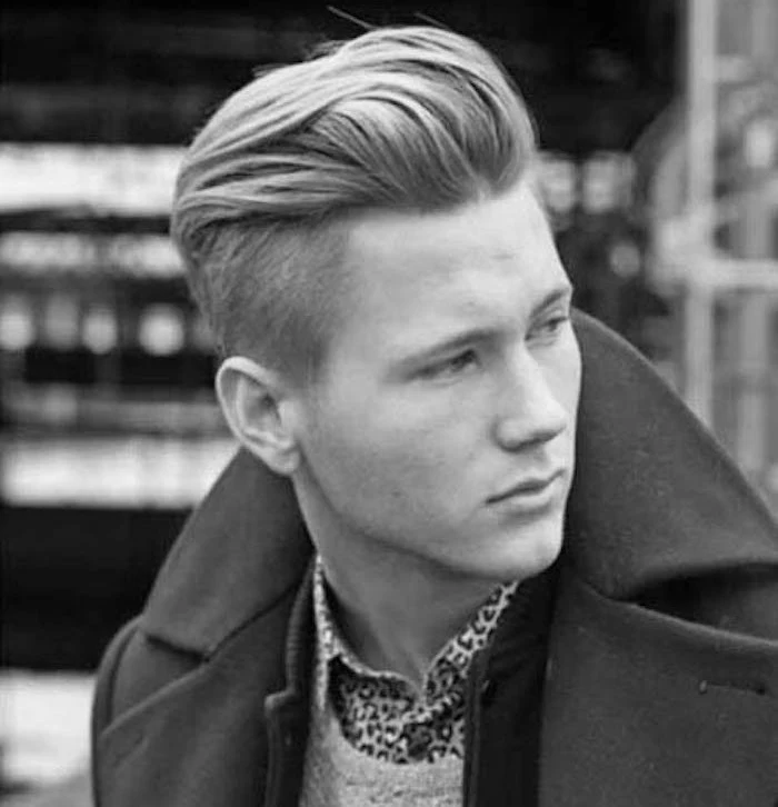 hairstyles for medium length hair, blonde young man with disconnected undercut and pompadour, wearing dark winter jacket