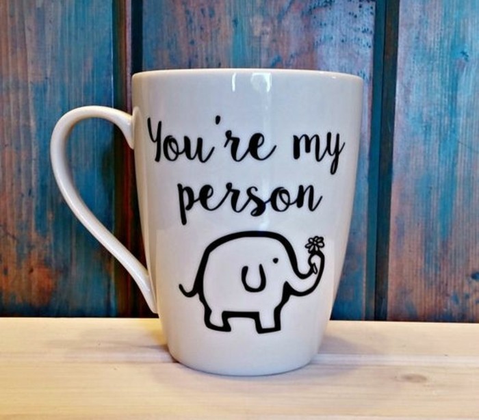 what to get your best friend for her birthday, white mug with black writing, and a drawing of a small elephant holding a flower