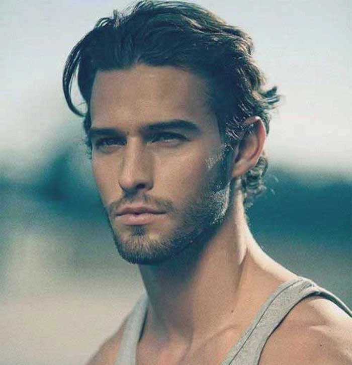 hairstyles for shoulder length hair, man with brushed back curly hair, stubble beard and mustache