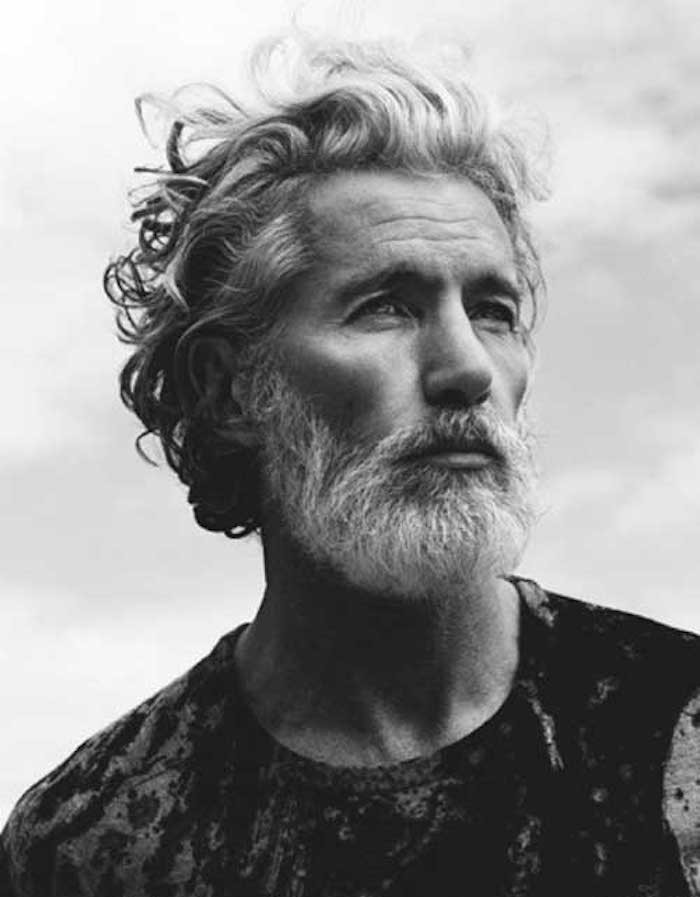 mid length hair, mature man with curly windswept white and grey hair, white beard and mustache