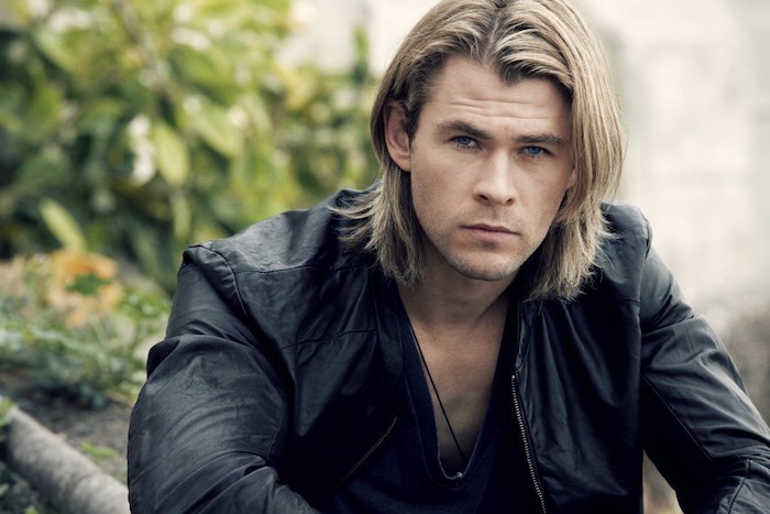 shoulder length hairstyles, blond man with black leather jacket, layered hair tucked behind one ear