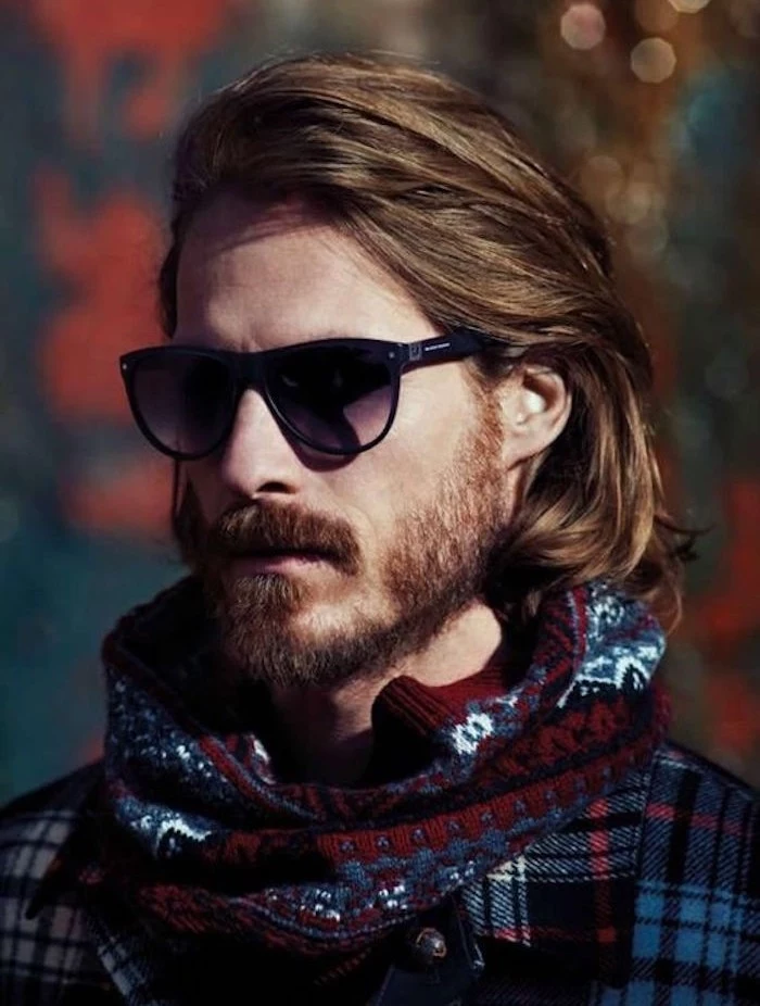 shoulder length haircuts, bearded man with sunglasses, hair partially tucked behind ear, scarf and plaid shirt