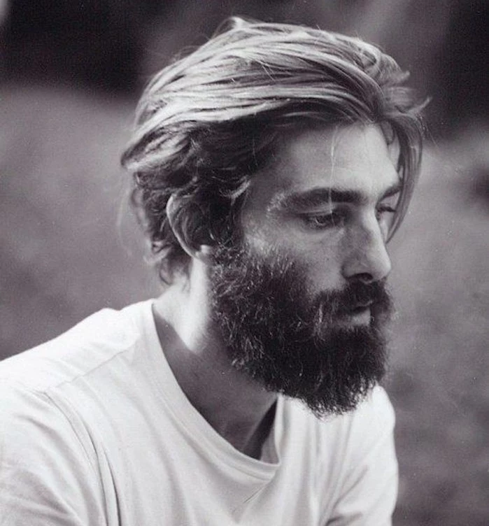 mid length hair, thoughtful man with big beard and white t-shirt, swept back hair with one lose strand