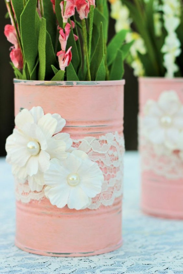 metal tin containers, close up of two cans, painted in pale pastel pink, decorated with lace and white fabric flowers, containing felt faux flowers