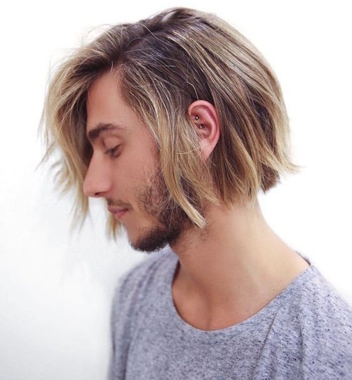 shoulder length haircuts, dirty blonde man in profile, stubbly beard and mustache, wearing grey t-shirt