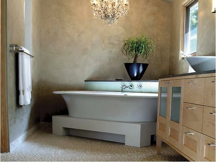 bathroom remodel ideas, room with mink-colored walls, cream colored pebble flooring, white ceramic bath