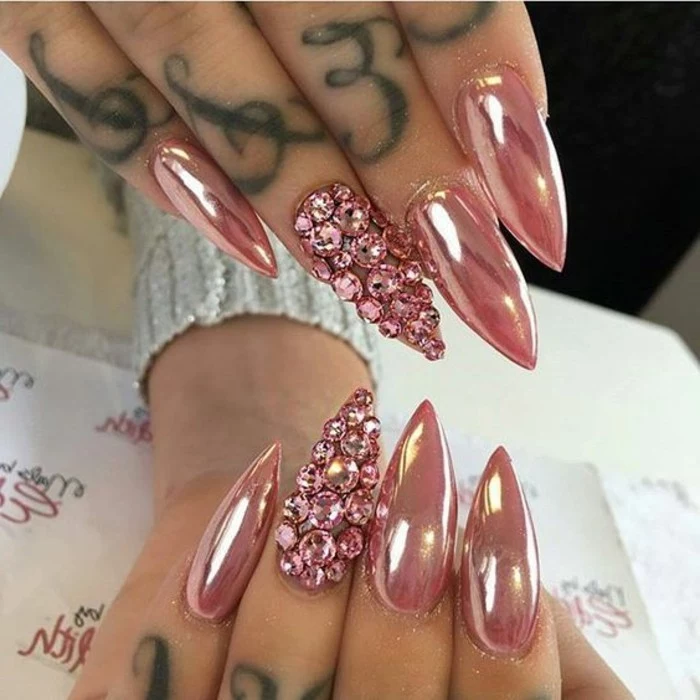 bling bling nails, eight long and sharp nails, metallic pink nail polish, ring fingers' nails covered with pink rhinestones