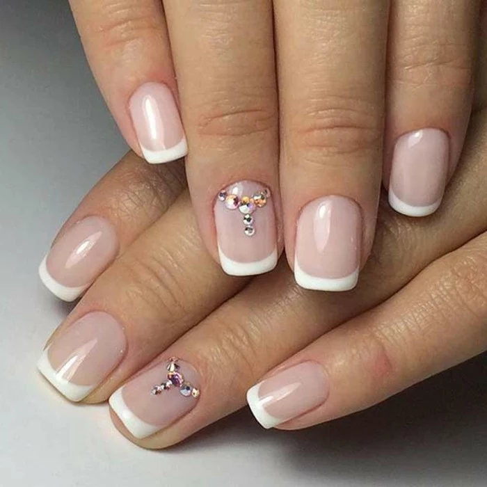 nails with rhinestones, simple classic french manicure, ring fingers' nails decorated with tiny white and pale pink rhinestones