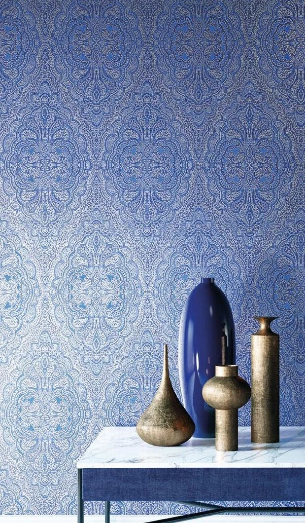 damask wallpaper in blue and white, intricate symmetrical floral pattern, table with four modern vases