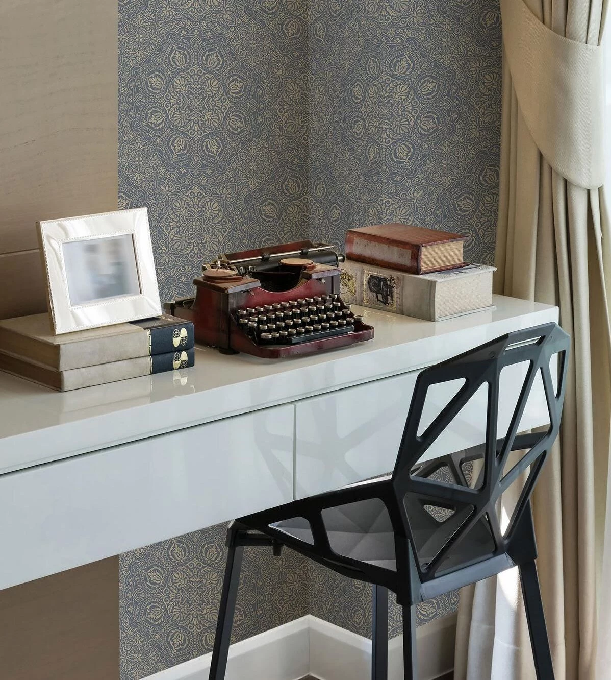 ornamental-wallpaper in blue and cream, symmetrical Moroccan design, desk with vintage typewriter and modern chair