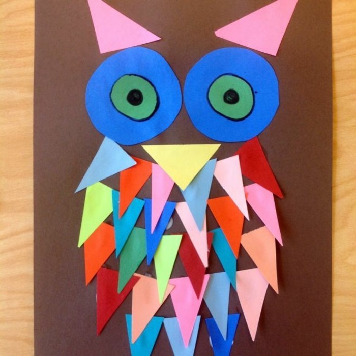 owl collage on brown paper, made from triangular and circular paper shapes in different colors