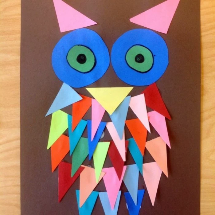 owl collage on brown paper, made from triangular and circular paper shapes in different colors