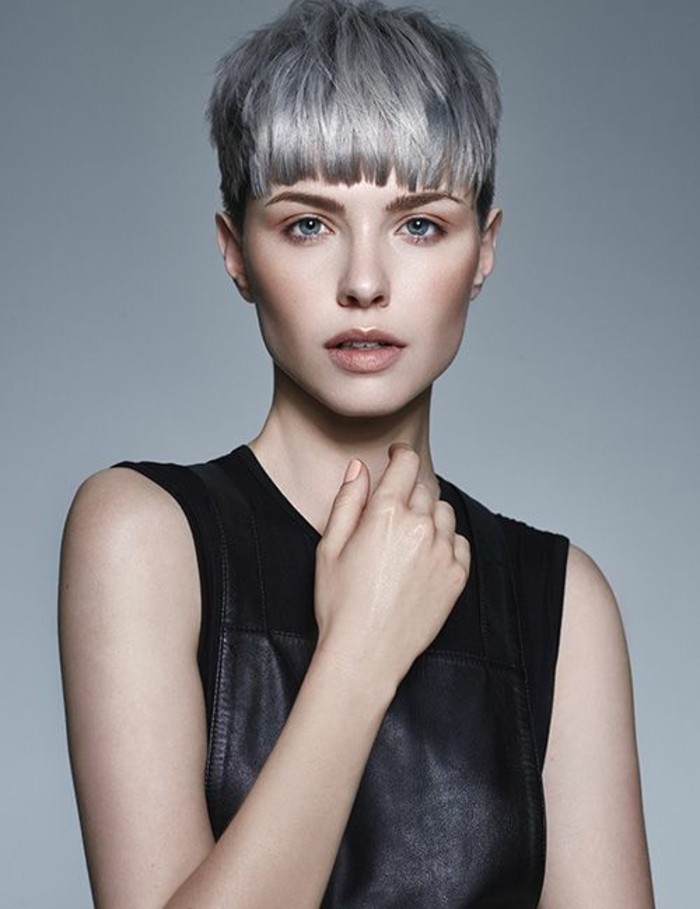 short hair cuts, slim woman with short light grey hair, layered cropped bangs, wearing black sleeveless leather top