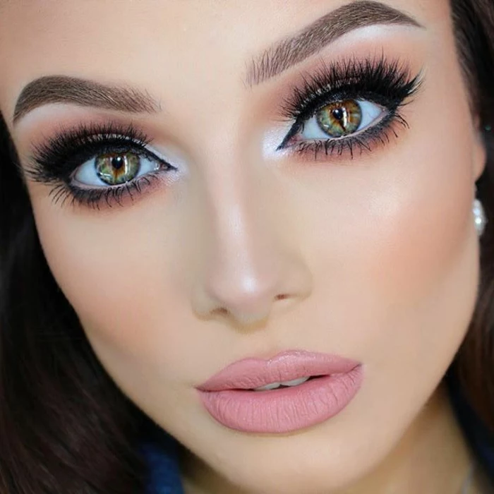 different colored eyes, woman with heavy make up, fake lashes and black eyeliner, silver eye shadow and pink matte lipstick