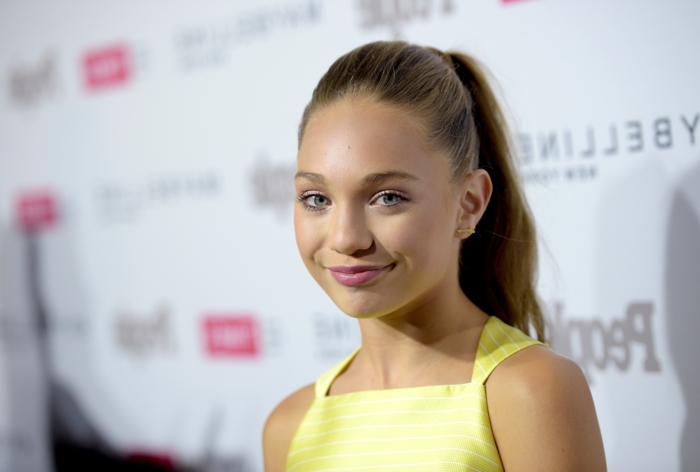 rarest eye color, Maddie Ziegler wearing yellow top, with blonde hair tied in ponytail, pink lipstick and green eyes