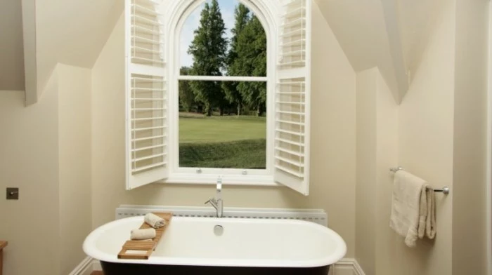 remodeling ideas, bathroom with cream walls, open window with white frames and blinds, white and black tub