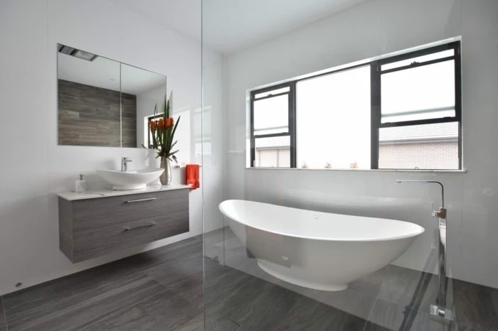 bathroom ideas photo gallery, grayish-brown wooden floor, white tub behind glass wall