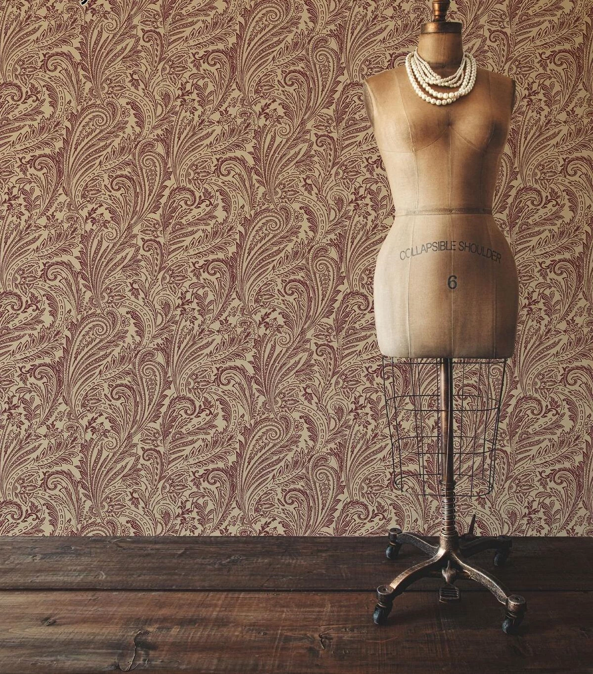baroque-inspired wallpaper, featuring dark red patterns, on a cream background, vintage dress-makers dummy and wooden floor