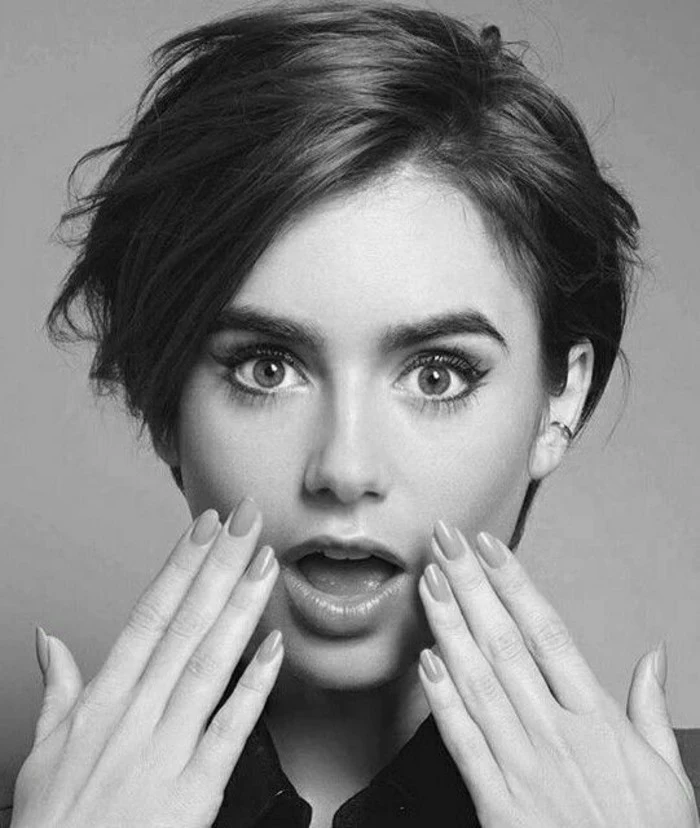 short haircuts, black and white image of lily collins, short dark hair with side bangs, looking surprised