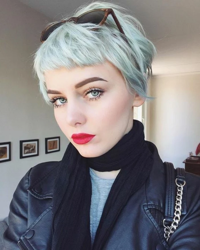 pixie cut, pale woman with short pale blue hair and cropped bangs, wearing bright red lipstick