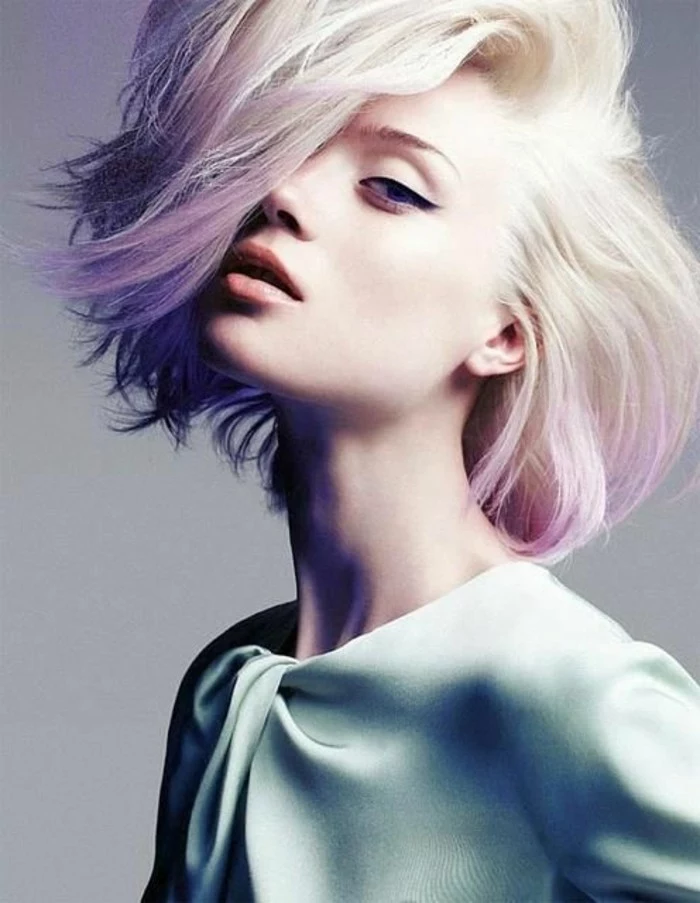 short hair cuts, woman with platinum blonde hair with pink ombre effect, bangs brushed to one side and covering her eye