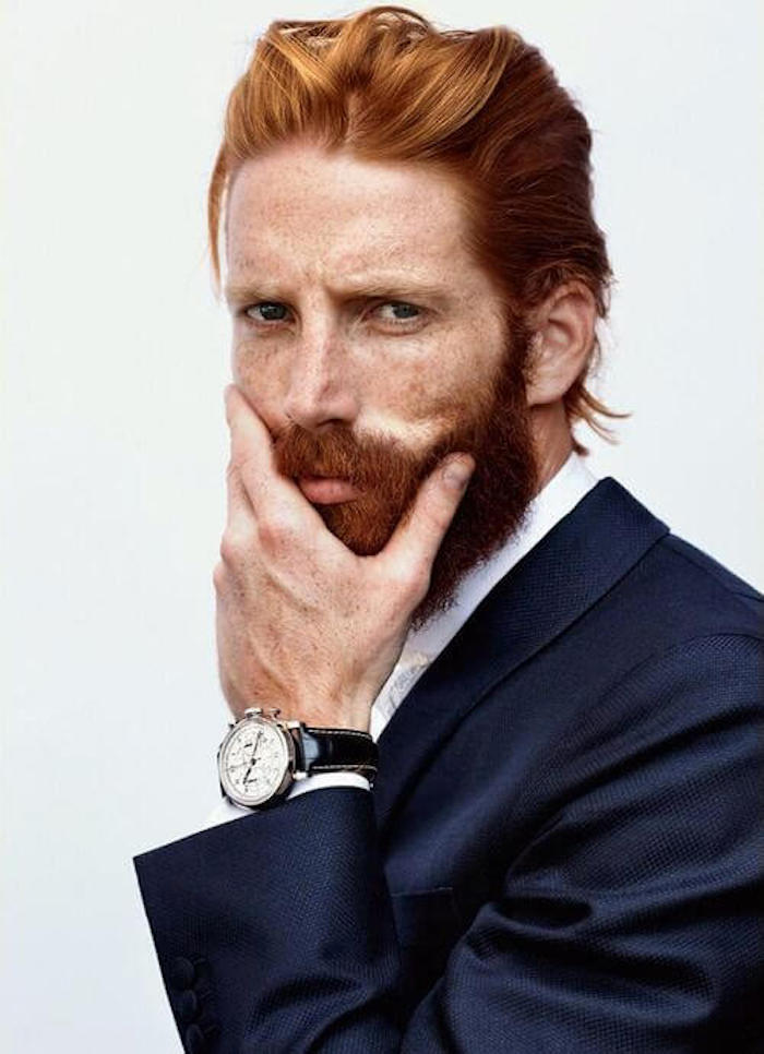 shoulder length hair, red-haired formally dressed man man with mustache and beard, hair slicked back and tucked behind ears