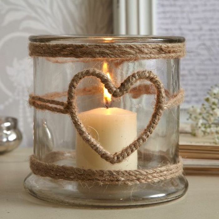 summer crafts, big jar decorated with burlap ropes, with heart-shape detail, containing one lit candle