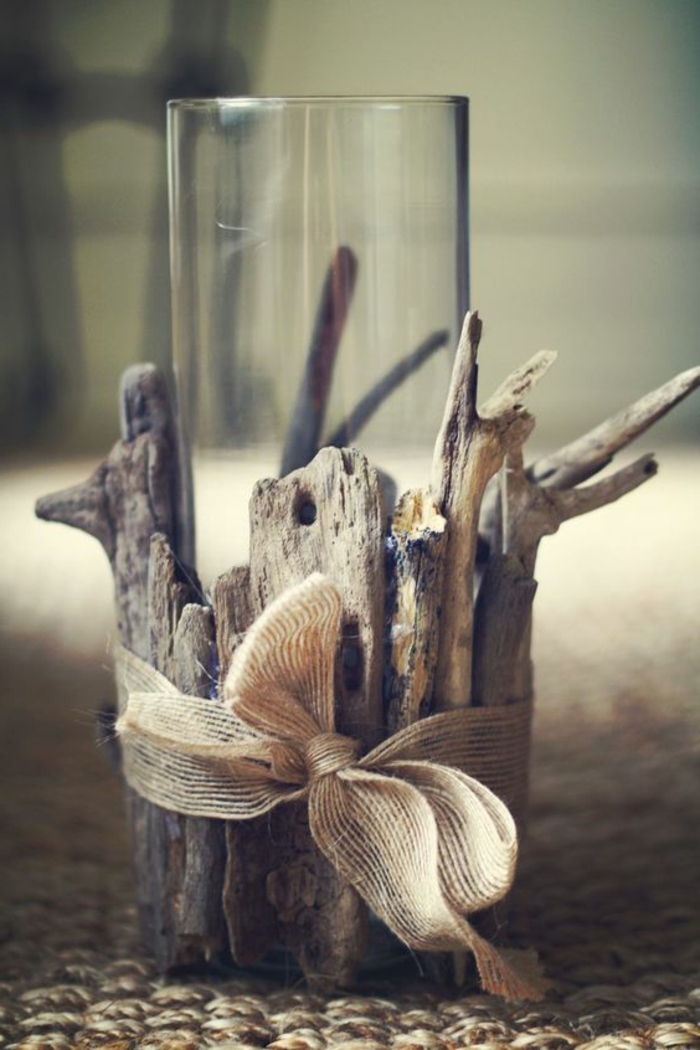 summer diys, clear tall glass, placed in holder made from asymmetrical pieces of driftwood, tied together with burlap bow