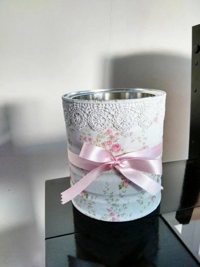 aluminum tins, can decorated with floral paper, with white lace and a pink ribbon tied around it