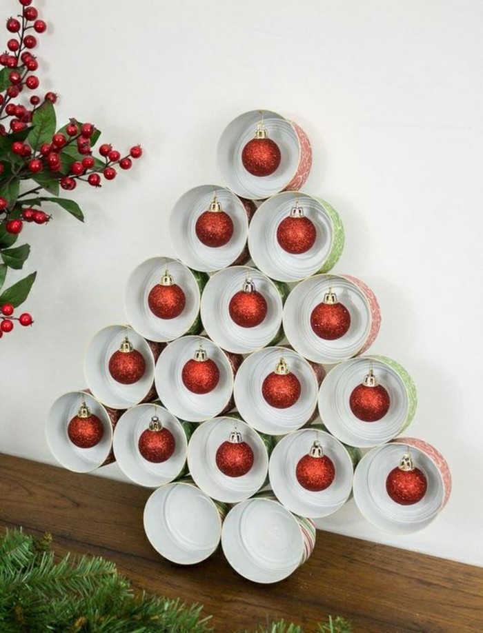 empty tin cans, christmas decoration made from empty cans, in the shape of a christmas tree, most cans contain red christmas ornaments