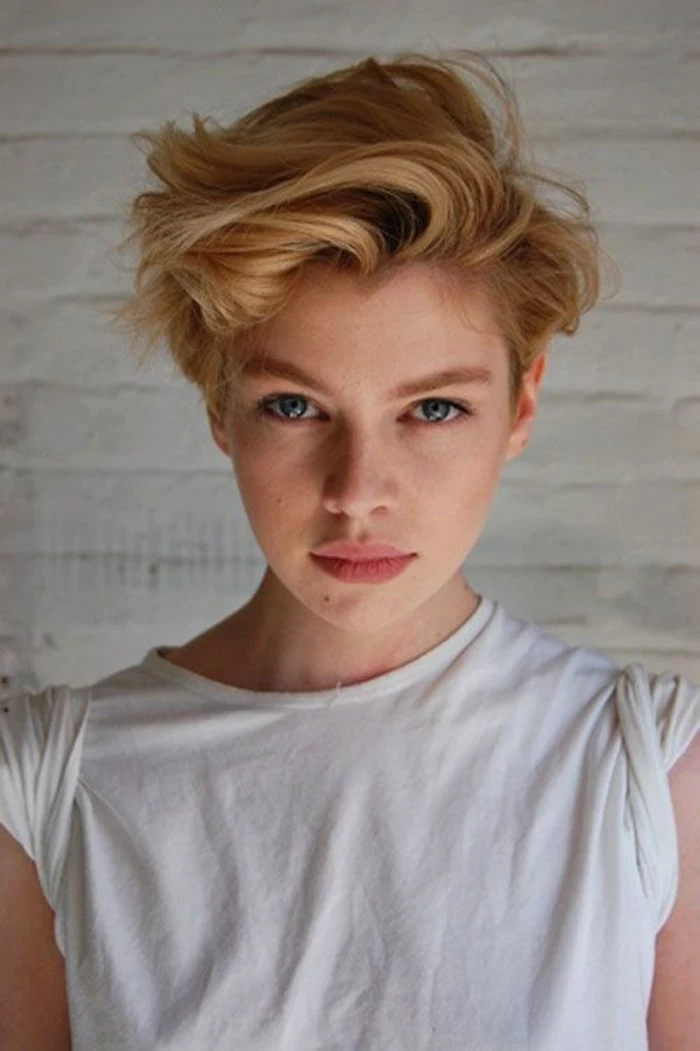 short hair cuts, young woman with very short, gelled up blonde hair, natural look and plain white t-shirt, with rolled sleeves
