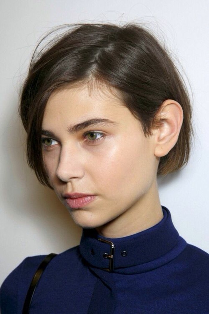 short haircuts, woman with short, side parted brown hair, natural-looking make up, and dark blue coat