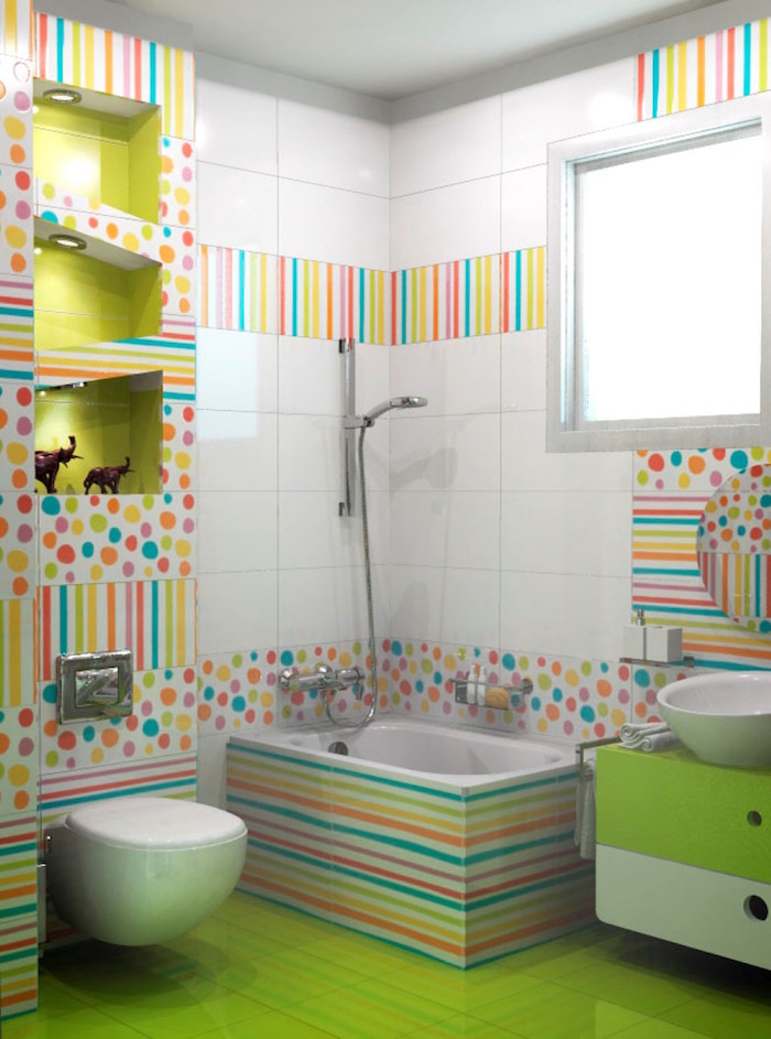 bathroom ideas, acid green tiles on floor, white tiles on walls, decorative tiles with multicolored dots and stripes, white toilet seat, small inbuilt tub, green cupboard with white sink, asymmetrical display shelves