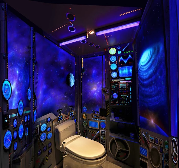 bathroom remodel, small toilet painted to look like a spaceship, dark blue walls, with murals of galaxies and stars, small flickering lights, various painted switches and machinery