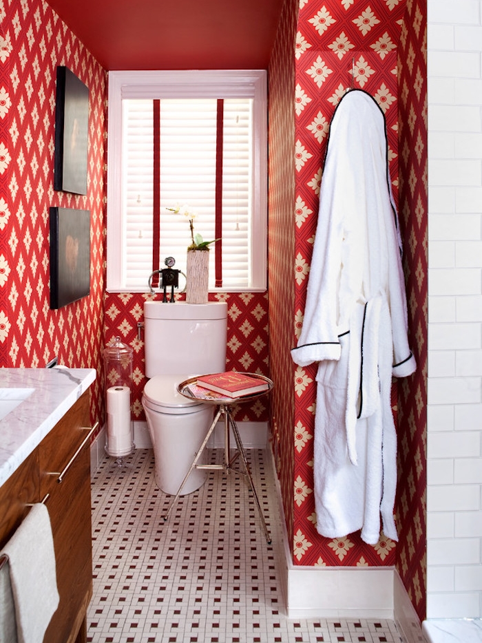small bathroom ideas, toilet with red and white patterned wallpaper, floor with small mosaic tiles, wooden cupboard with white sink, white toilet seat and window with blinds