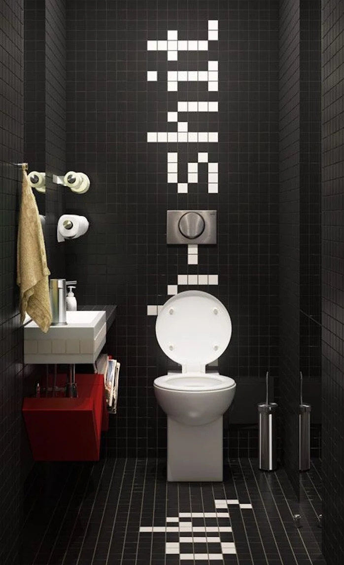 bathroom decorating ideas, bathroom with high ceiling, entirely covered in small black tiles, with a humorous message written sideways with white tiles, oval white toilet seat and square, black and white sink
