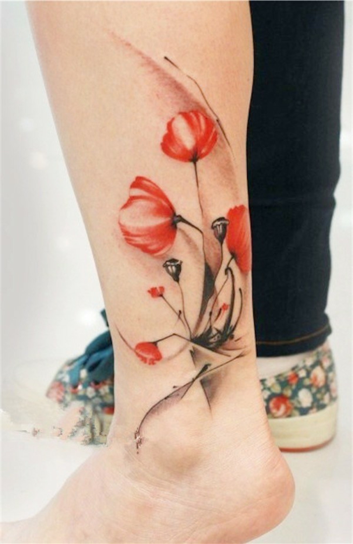 red and black, watercolor-effect tattoo, of several poppies, with dark bending stalks, on a person's ankle