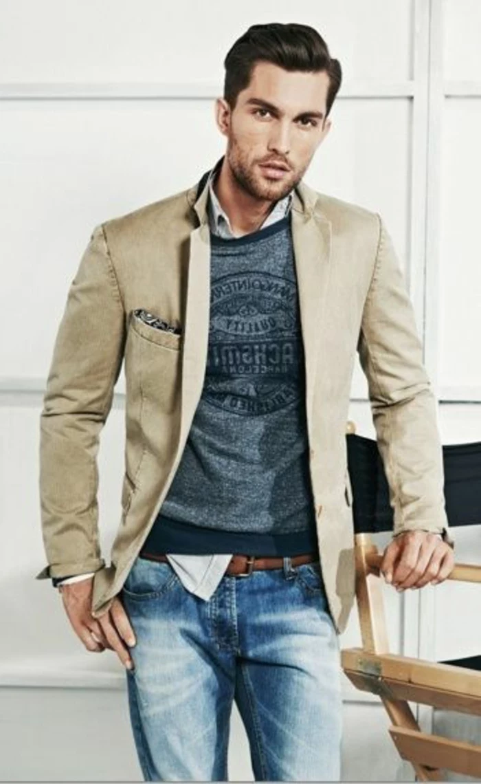 beige blazer over blue-grey printed tee, and pale shirt, worn with faded jeans, business casual outfits, man with brushed back hair