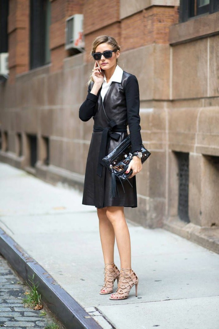 business casual women, olivia palermo with tied back blonde hair, wearing black leather wrap-over dress, with textile sleeves and belt