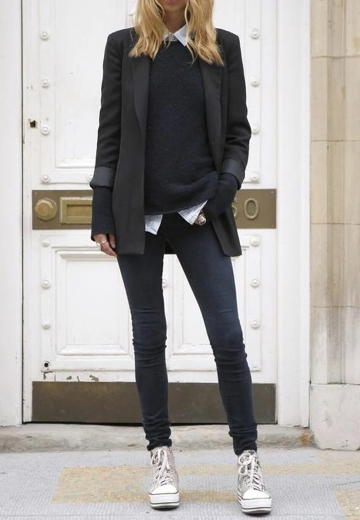 women business casual, long black blazer, worn over white shirt and black sweater, by blonde woman in skinny dark grey jeans, and cream and white sneakers