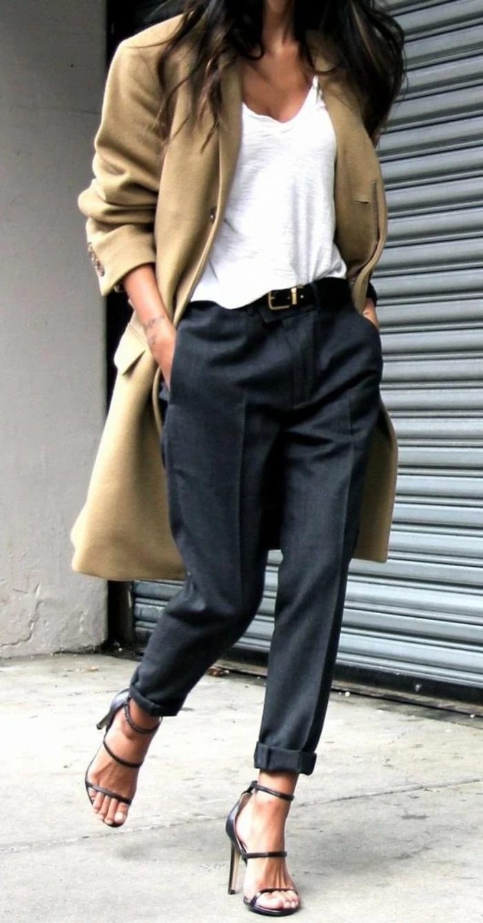 women business casual, oversized camel colored coat, worn over plain white top, tucked into dark grey woolen trousers with belt, worn by brunette woman in high-heeled sandals