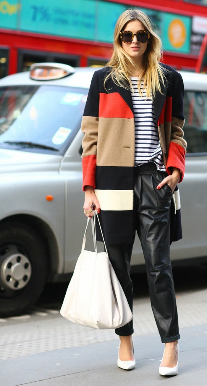 business casual for young women, black and red, beige and white block color coat, worn by blond woman with sunglasses, over white and black striped top, and baggy leather trousers with pockets