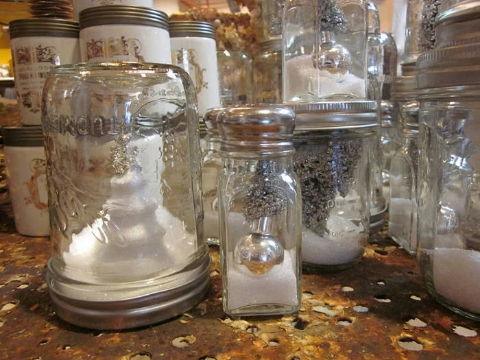 christmas mason jars, many different jars, filled with fake snow, and silver glittering christmas ornaments