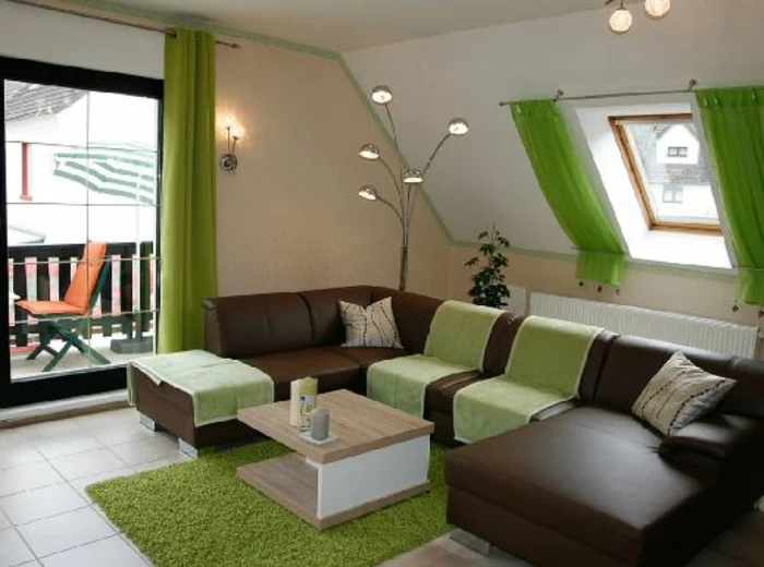 curtains for living room, brown leather sofa, small light wooden table, terrace door and small window, both decorated with vivid, light green curtains