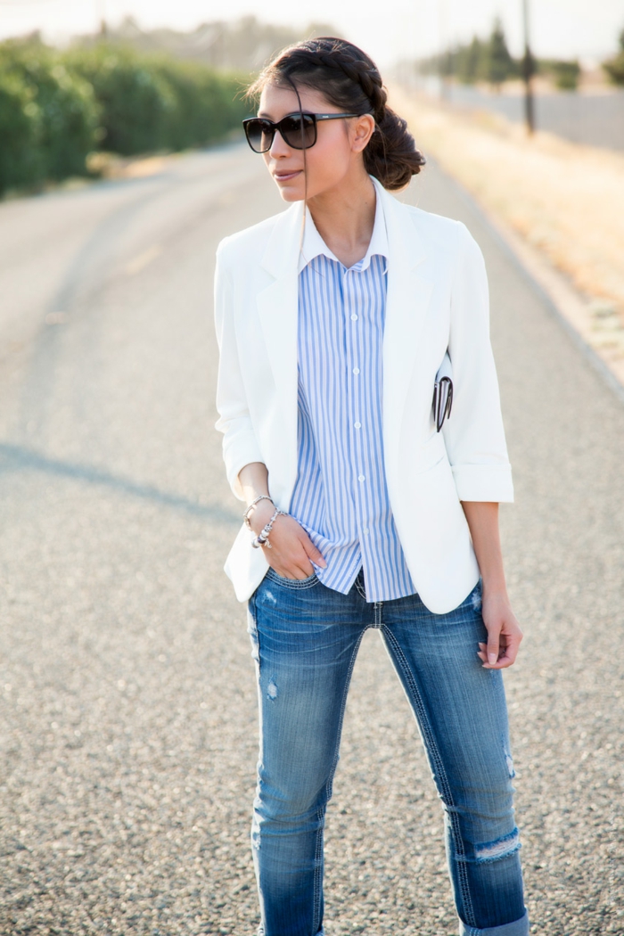 woman with dark hair tied back, wearing white blazer, over pale blue pin stripe shirt, business casual outfits