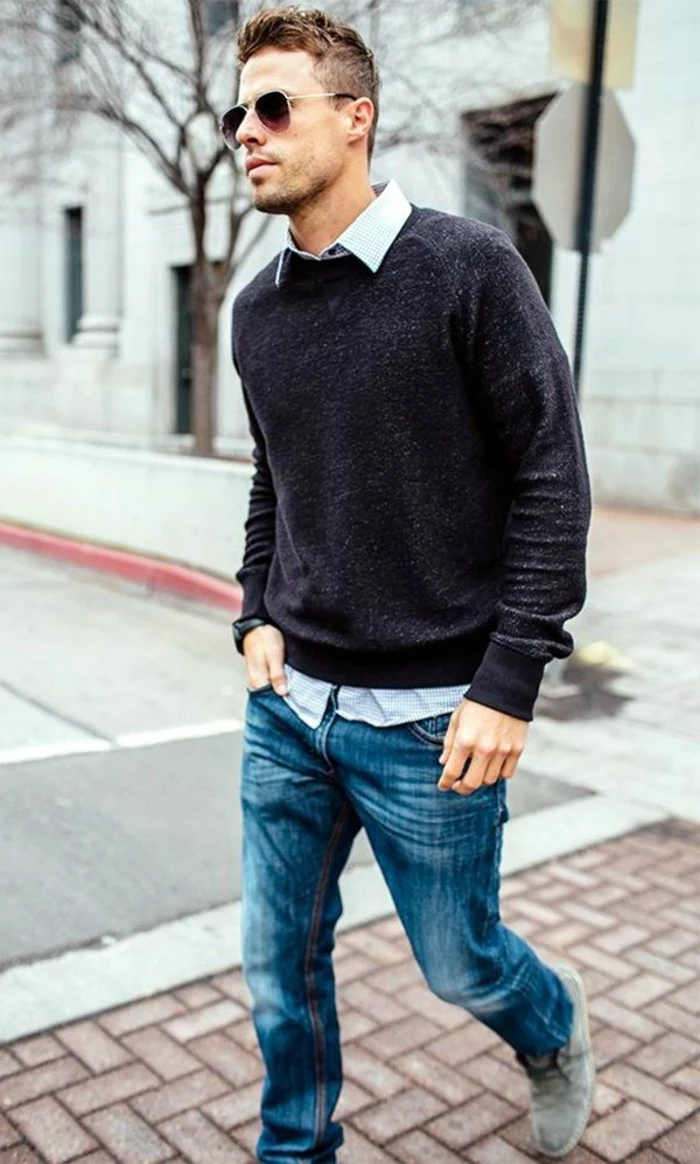 walking man with business casual jeans, combined with dark grey jumper, white shirt, and sunglasses