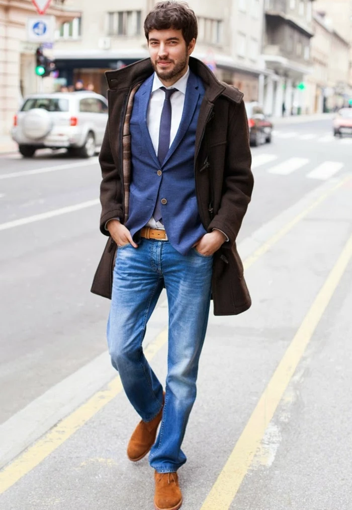 smartly-dressed bearded man, with brown coat, distressed jeans and blue blazer, white shirt and dark blue tie, business casual men